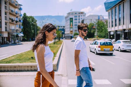Full length portrait of happy couple, young man and woman on romantic date in downtownの写真素材