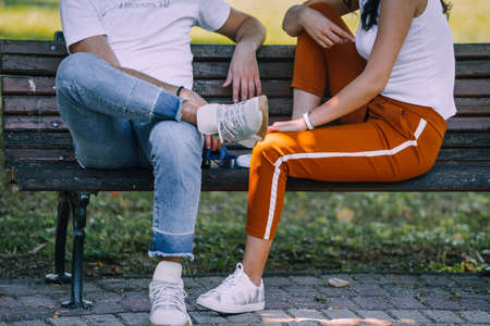 Young affectionate couple embracing in park in autumnの写真素材