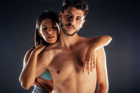 Beautiful romantic half naked couple embracing each other intimatelyの写真素材