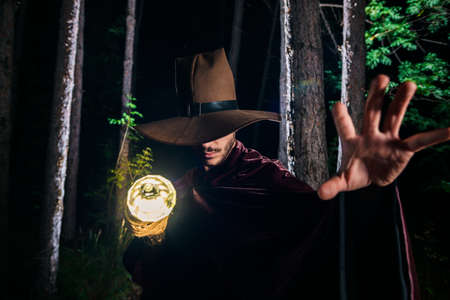 Male with a mystical glowing stick to signify power, magic, spirituality and so forthの写真素材