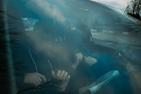 bank robbers putting their mask on prepared to do their next robbery,checking and loading their guns.の写真素材