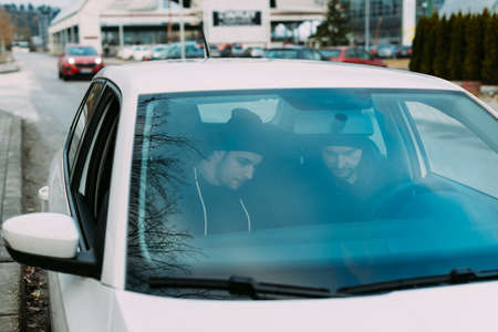 Thieves parked in an ally waiting and planning the way they will rob their target.の写真素材