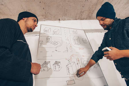 Housebreakers standing near the map and planning a crimeの写真素材