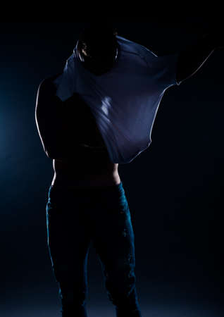 Sport bodybuilding strength and people concept young man standing over black backgroundの写真素材