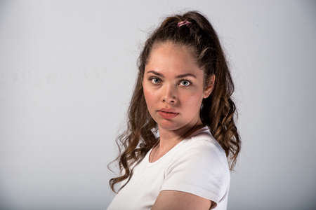 Portrait of an attractive stylish woman posing against white backgroundの写真素材