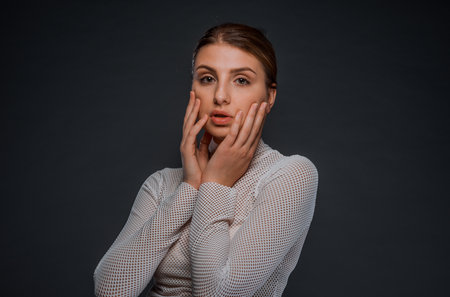 Portrait of a young woman dressed in fishnet sexy shirtの写真素材