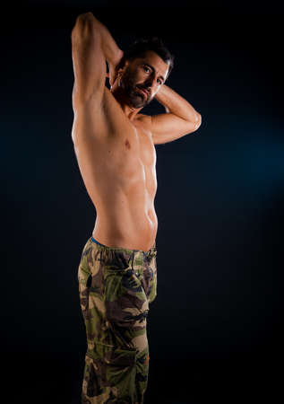 Portrait of a physically fit man showing his well trained bodyの写真素材