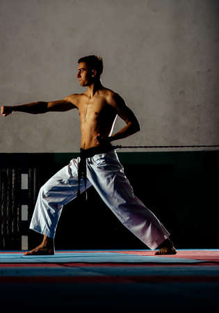 Fighting concept. Fighting man in kimono pants. Karate man in fighting stance. Keep fightingの写真素材