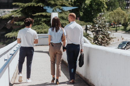 Young businesspeople walking outsideの写真素材