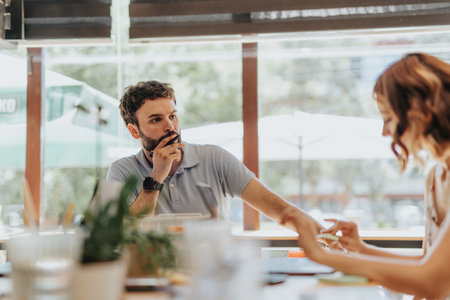 A diverse group of professionals working together in an office, focused on marketing strategies and...