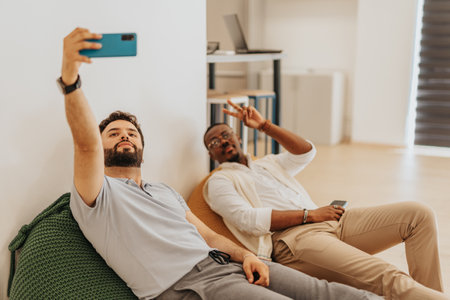 Multiracial employees taking a selfie at workの写真素材
