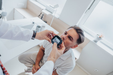 Doctor using video laryngoscope checking young patients throat. Checking throat concept.