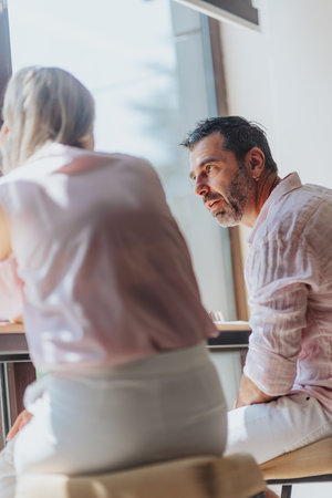 Confident business group analyzing statistics and reports in a modern office. Focused on teamwork, innovation, and targeting audience for success.の写真素材