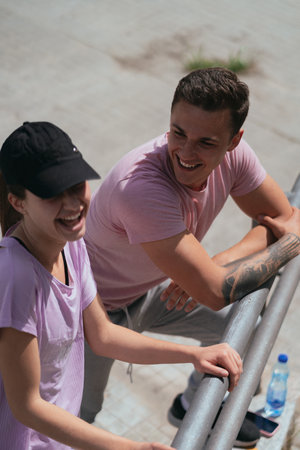 A shot of beautiful sports couple taking a break from workout.They are having fun conversation and...