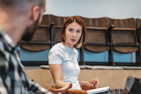 Beautiful business girl asking if true after she heard unpleasant news at work by her male coworker