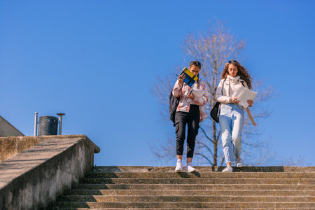 High school girls reading books and walking downstairs