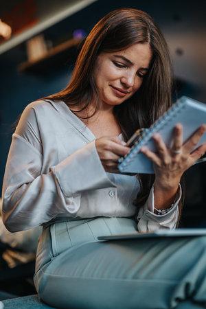 Successful female employee diligently researching and analyzing online to drive profit growth in a...
