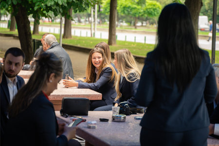 A group of students and faculty members taking a break at the university quad.の写真素材