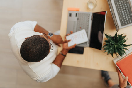 Persistent Executive Gathering Information for Business Ideas and Market Research at a Working Desk...
