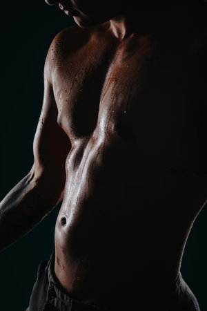 Confident Male Athlete Flexing Muscles, Showing Progress in Body Transformation