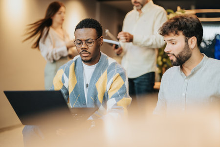 Multiracial Group of Confident Employees Discussing Business Strategies in a Modern City Center Co-Work Spaceの写真素材