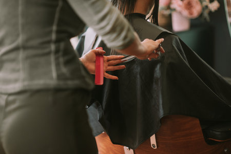 Professional hair stylist cutting clients hair in the beauty salon. Close up shopの写真素材