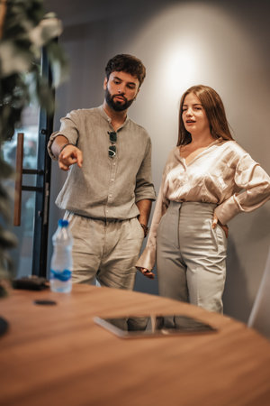 Experienced entrepreneurs working in a modern downtown co-work space, analyzing market research and networking for successful stock market growth.の写真素材
