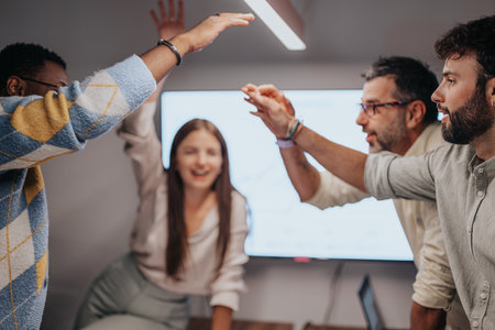Business Professionals Collaborating on Architectural Plans in a Multinational Companys Conference Roomの写真素材