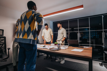 A diverse team of architects and business professionals collaborate in a boardroom, discussing a blueprint for a project.の写真素材