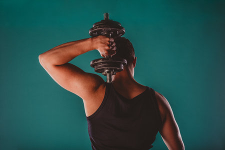 A confident, fit man showcases his muscles and motivates with a powerful workout.の写真素材