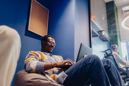 Diverse colleagues collaborating confidently in a creative co-working space, solving problems and...