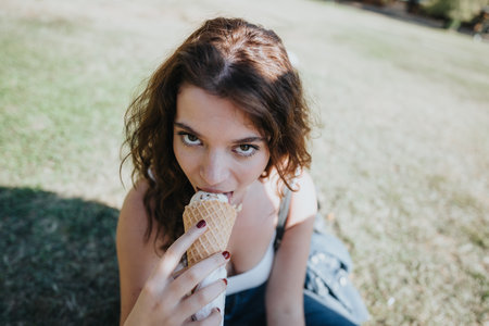 Carefree Friends Enjoying a Sunny Day in the Park, Laughing and Eating Ice Cream