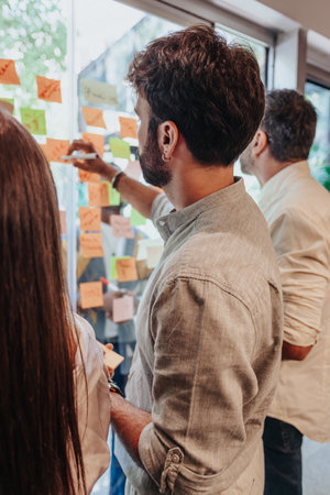 Multigenerational Business Team Brainstorming and Sharing Ideas in Modern Office