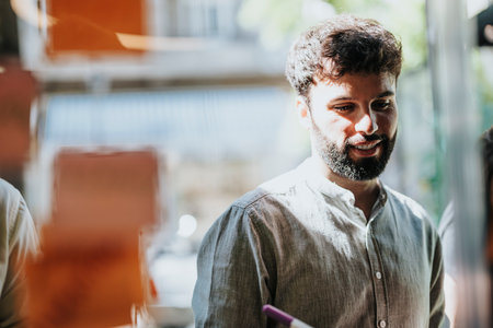 Multiracial Business Team Collaborating and Brainstorming on Glass Wallの写真素材