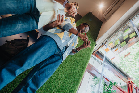 Diverse colleagues brainstorm and collaborate, sharing ideas on sticky notes. Multiracial team in a modern office, focused on teamwork and innovation.の写真素材