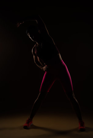 A full length photo of woman warming up her spineの写真素材