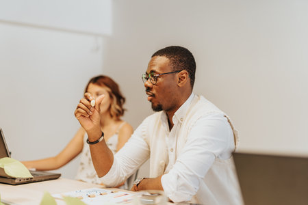 Business professionals collaborate in a modern meeting, discussing growth, innovation, and strategy for their companys success.の写真素材