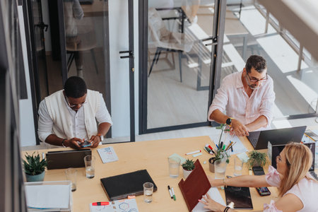A focused group analyzes statistics, works on e-commerce, and collaborates in a modern office for...