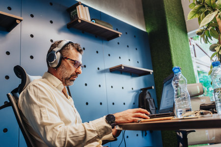 Collaborating in a Creative Workspace: Diverse Team of Successful Entrepreneurs Solving Problems and...