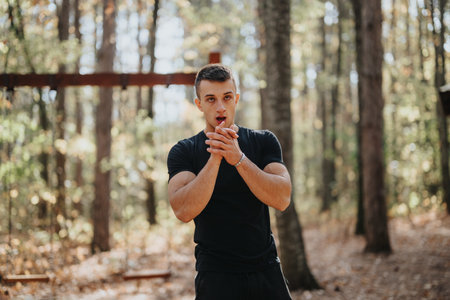Healthy male hiker enjoys sunny day exploring green forest. Active lifestyle embraces outdoor...