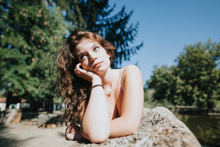 Cheerful friends embracing natures freedom in a green city park. Enjoying conversations, laughter, and positive energy on a sunny day off.の写真素材