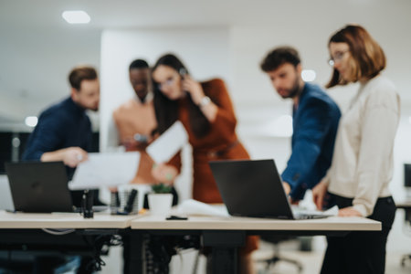 Business professionals collaborate in a creative office, analyzing reports, discussing strategies, and brainstorming for business growth.の写真素材
