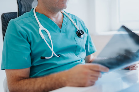 Doctor analyzing x-ray, giving diagnosis to young patient. Specialized treatment for bronchitis...