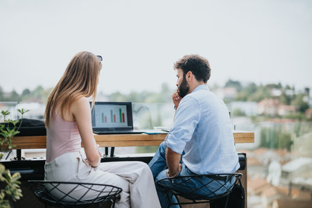 Successful Business Couple Meeting in Urban Cafe to Discuss New Projects and Expansion Plansの写真素材