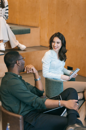 Diverse coworkers taking a break. Multiracial colleagues, male and female, having fun conversation...
