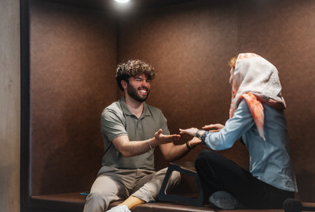 Two happy people smiling while sitting downの写真素材