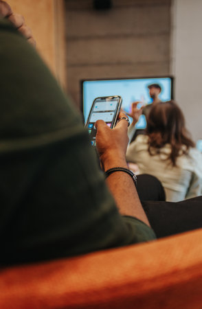 Male employee checking phoneの写真素材