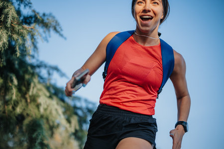 Two fit runners training outdoors in the park together.