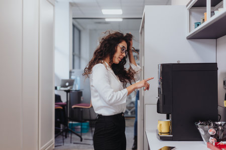A businesswoman takes a well-deserved tea break in a modern, multicultural office.