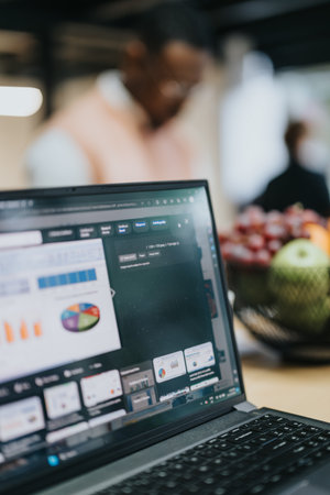 Diverse professionals analyzing data, discussing business expansion and sales strategy, working together in a creative office.の写真素材